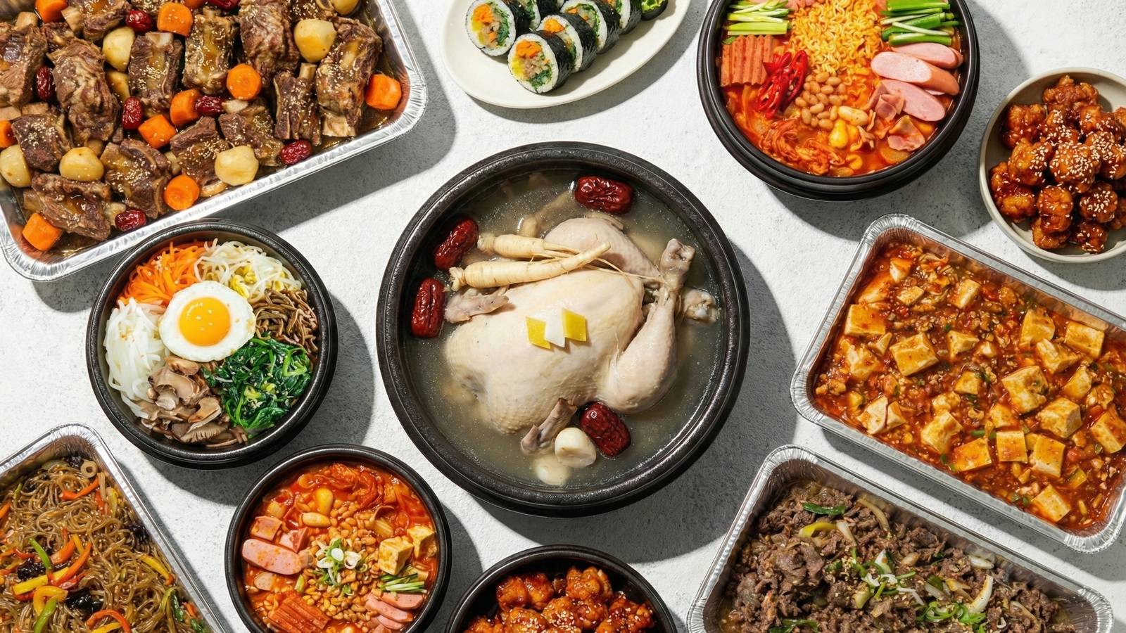 Korean catering spread: galbi-jjim, kimbap, budae jjigae, samgyetang, bibimbap, mapo tofu, japchae, bulgogi, wings
